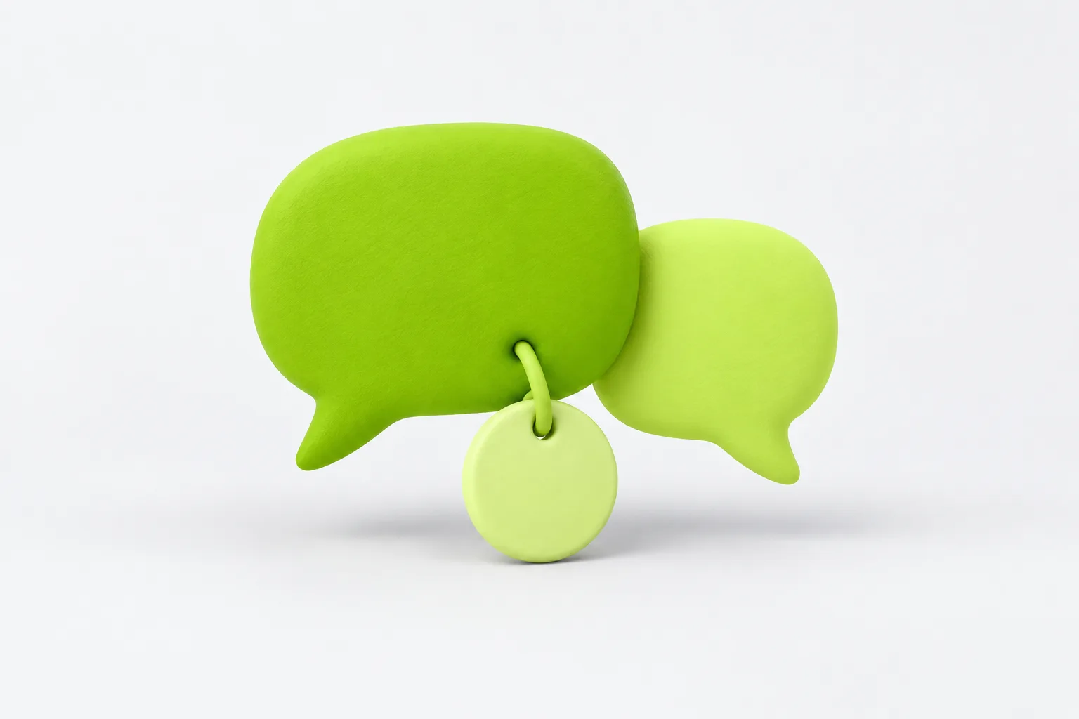 A matte lime-green clay message shape with a small blank tag hanging from it on a looped cord, beside a smaller plain one